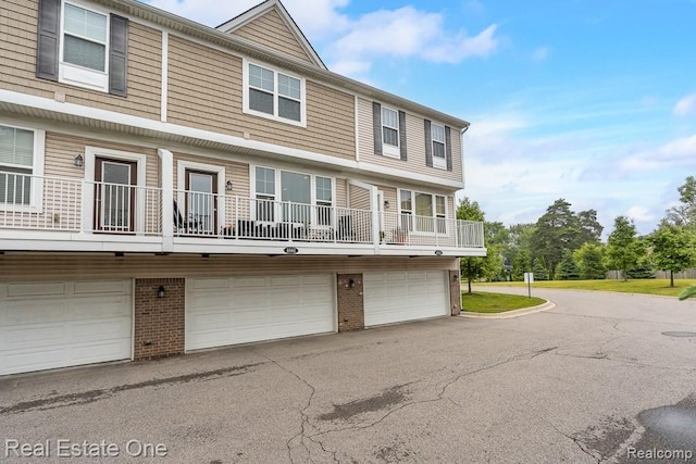 4661 Bradley Cir, Troy, MI 48085 - view of property with an attached garage, brick siding, and driveway