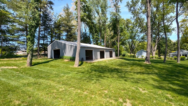 66109 Hideaway Ln, Sturgis, MI 49091 - view of green lawn featuring a garage, an outdoor structure, and a pole building