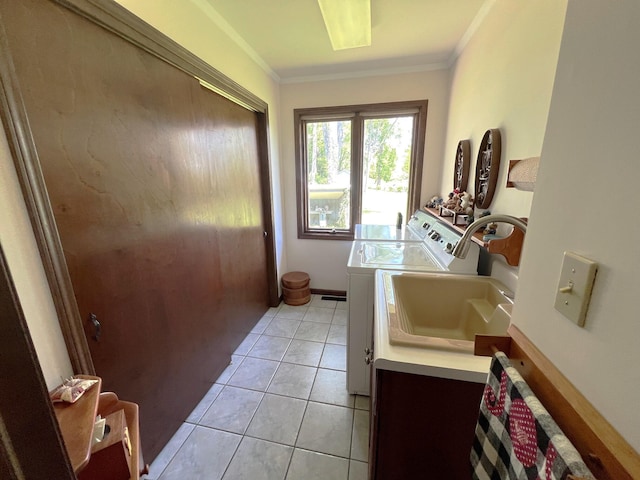 66109 Hideaway Ln, Sturgis, MI 49091 - laundry area with washing machine and clothes dryer, ornamental molding, and light tile patterned flooring