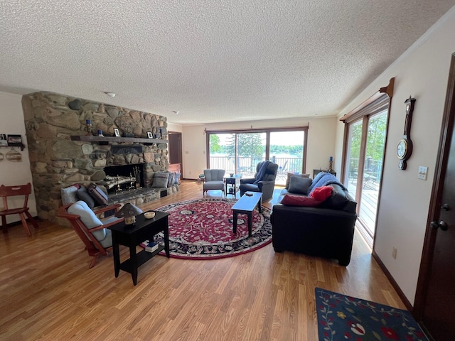 66109 Hideaway Ln, Sturgis, MI 49091 - living room with a textured ceiling, light wood finished floors, and a stone fireplace