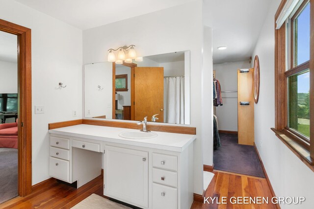 2229 Brighton St, Holland, MI 49424 - bathroom with wood finished floors, vanity, and baseboards
