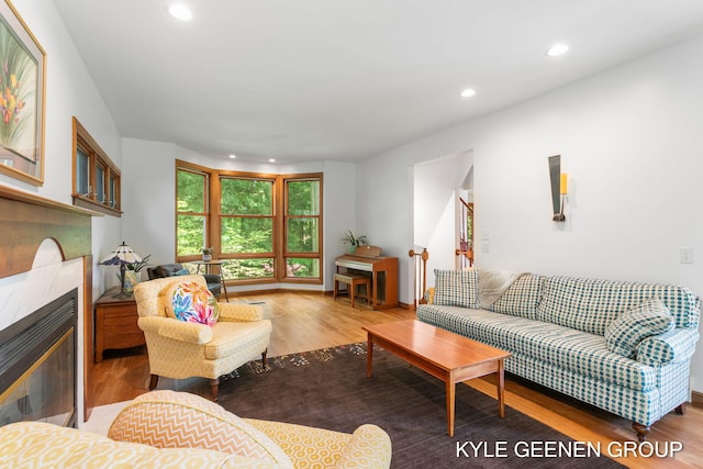 2229 Brighton St, Holland, MI 49424 - living room featuring wood finished floors, recessed lighting, a glass covered fireplace, and baseboards