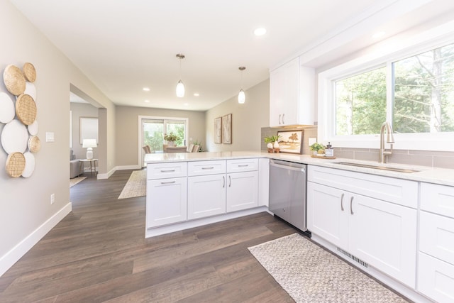2971 Daleview Dr, Ann Arbor, MI 48105 - kitchen with stainless steel dishwasher, a sink, a peninsula, white cabinetry, and light countertops
