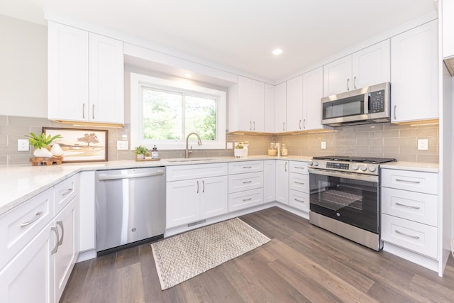 2971 Daleview Dr, Ann Arbor, MI 48105 - kitchen featuring stainless steel appliances, a sink, white cabinetry, dark wood-type flooring, and recessed lighting