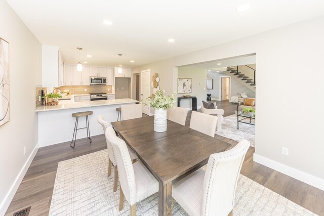 2971 Daleview Dr, Ann Arbor, MI 48105 - dining room featuring stairway, dark wood-style flooring, recessed lighting, and baseboards