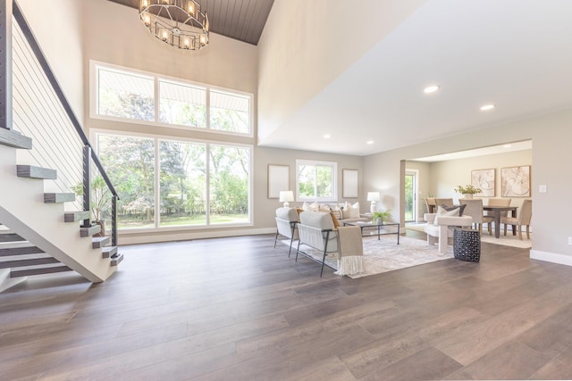 2971 Daleview Dr, Ann Arbor, MI 48105 - living area featuring dark wood finished floors, a chandelier, stairway, baseboards, and a high ceiling