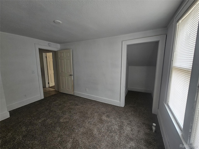 48 W Charlotte St, Ecorse, MI 48229 - unfurnished bedroom featuring dark colored carpet, a textured ceiling, ornamental molding, a spacious closet, and baseboards