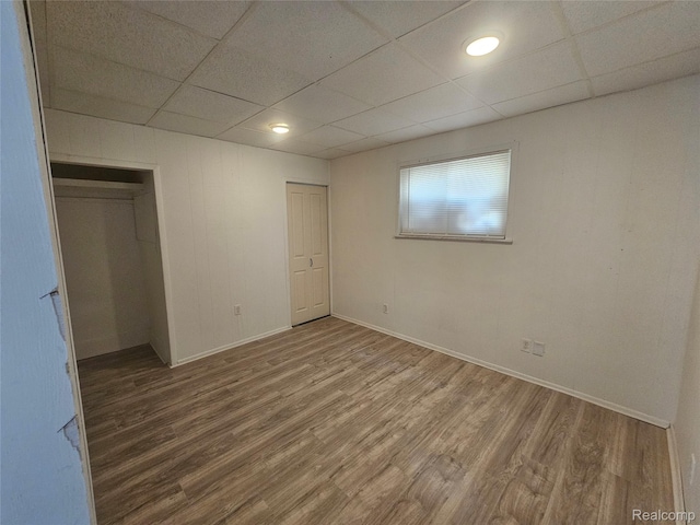48 W Charlotte St, Ecorse, MI 48229 - unfurnished bedroom featuring a paneled ceiling, wood finished floors, and baseboards