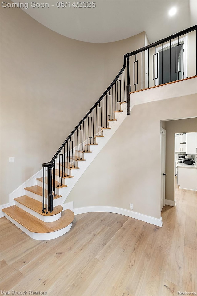 3546 Bloomfield Club Dr, Bloomfield Hills, MI 48301 - staircase with wood finished floors, baseboards, and a towering ceiling