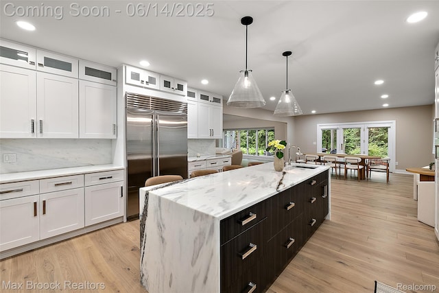 3546 Bloomfield Club Dr, Bloomfield Hills, MI 48301 - kitchen featuring stainless steel built in fridge, white cabinetry, a sink, decorative backsplash, and recessed lighting