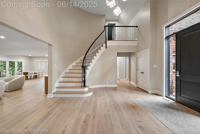 3546 Bloomfield Club Dr, Bloomfield Hills, MI 48301 - entrance foyer with high vaulted ceiling, stairway, wood finished floors, and baseboards
