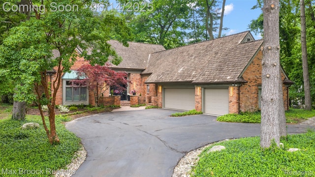 3546 Bloomfield Club Dr, Bloomfield Hills, MI 48301 - tudor home with driveway, brick siding, and a garage