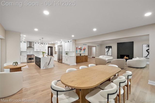 3546 Bloomfield Club Dr, Bloomfield Hills, MI 48301 - dining area with a large fireplace, recessed lighting, light wood-type flooring, and baseboards