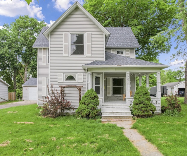 405 E Saginaw St, Saint Louis, MI 48880 - view of front of home featuring a shingled roof, a porch, a front lawn, and a detached garage