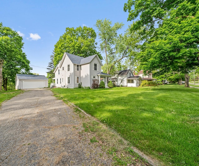 405 E Saginaw St, Saint Louis, MI 48880 - view of front of home with an outbuilding, a garage, and a front lawn