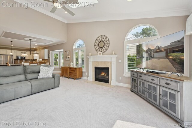 446 Delmar Ct, Highland, MI 48357 - living area with ceiling fan, ornamental molding, light colored carpet, a fireplace with flush hearth, and plenty of natural light