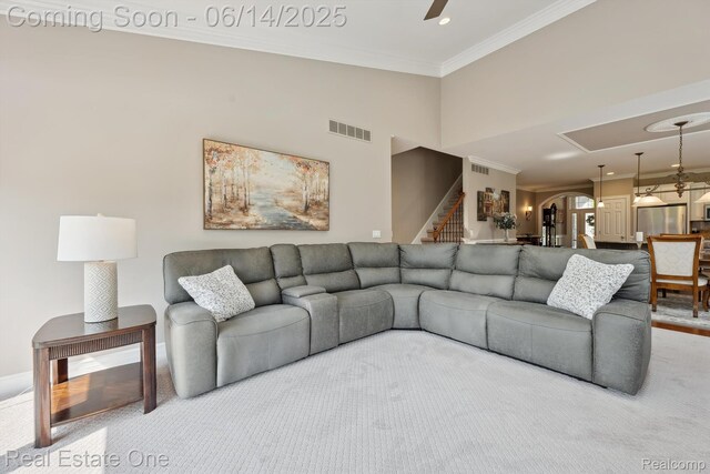 446 Delmar Ct, Highland, MI 48357 - living area with stairway, ornamental molding, and a ceiling fan