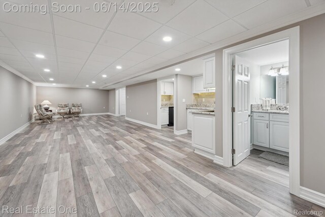 446 Delmar Ct, Highland, MI 48357 - unfurnished living room with light wood finished floors, recessed lighting, and baseboards