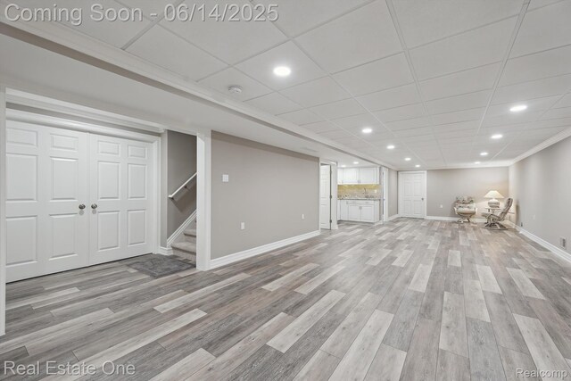 446 Delmar Ct, Highland, MI 48357 - finished basement with baseboards, light wood-style floors, recessed lighting, and stairs