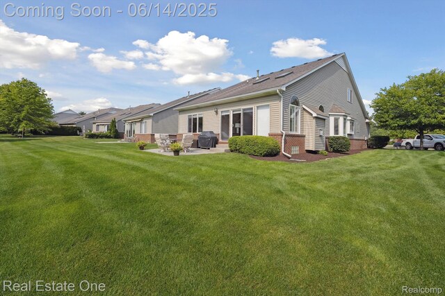 446 Delmar Ct, Highland, MI 48357 - back of property featuring a patio, a yard, brick siding, and a shingled roof