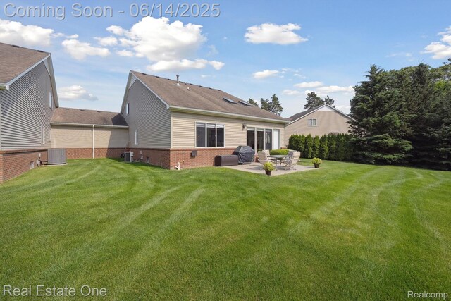 446 Delmar Ct, Highland, MI 48357 - back of property with a patio area, central AC, brick siding, and a yard