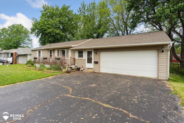 7131 Houghton Dr, Davison, MI 48423 - ranch-style home with asphalt driveway, a garage, and a front yard