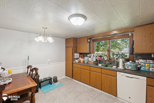 7131 Houghton Dr, Davison, MI 48423 - kitchen with dishwasher, a sink, dark countertops, and brown cabinetry
