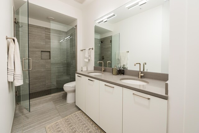 218 W Kingsley St Unit 507, Ann Arbor, MI 48103 - full bath with double vanity, a shower stall, toilet, and tile patterned floors