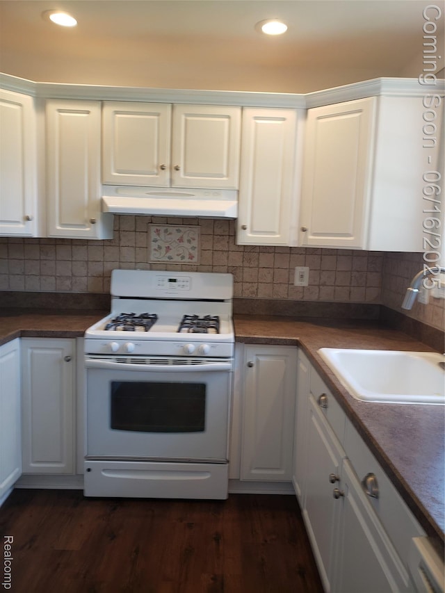 8224 Milburn St, Westland, MI 48185 - kitchen with white range with gas stovetop, under cabinet range hood, white cabinets, dark wood-style floors, and recessed lighting