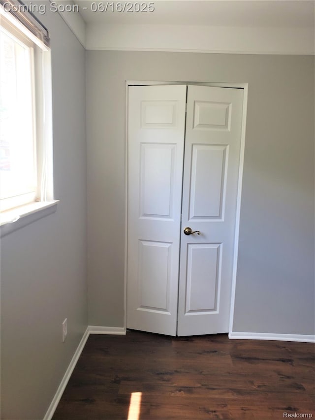 8224 Milburn St, Westland, MI 48185 - unfurnished bedroom with dark wood-style flooring and a closet