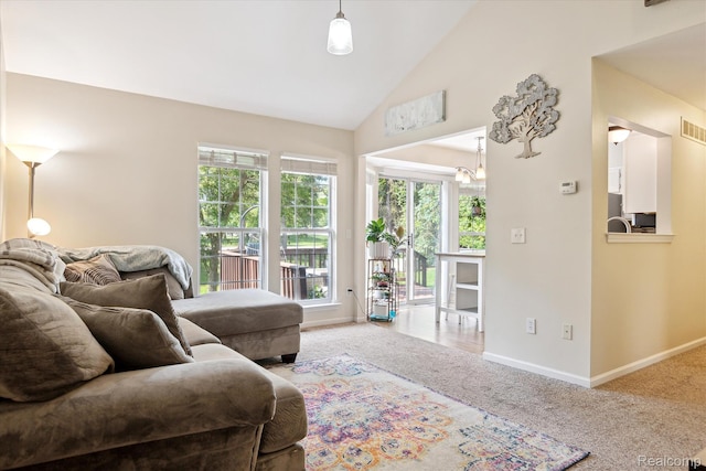 43687 Christopher Ct, Canton, MI 48188 - carpeted living room featuring baseboards, high vaulted ceiling, and a chandelier
