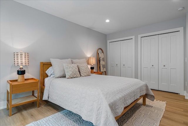 4067 Hillside Trl, New Buffalo, MI 49117 - bedroom featuring multiple closets, light wood-style floors, baseboards, and recessed lighting