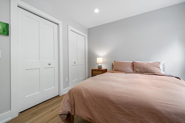 4067 Hillside Trl, New Buffalo, MI 49117 - bedroom featuring light wood finished floors, recessed lighting, and multiple closets