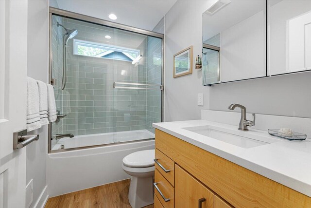 4067 Hillside Trl, New Buffalo, MI 49117 - full bathroom with vanity, toilet, wood finished floors, shower / bath combination with glass door, and recessed lighting