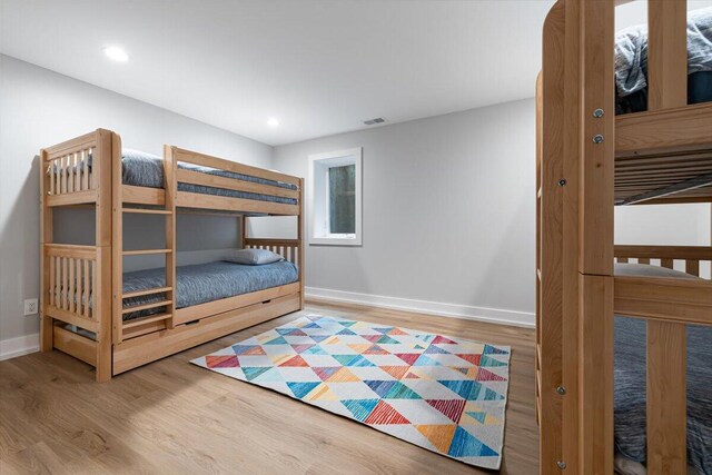 4067 Hillside Trl, New Buffalo, MI 49117 - unfurnished bedroom featuring wood finished floors, baseboards, and recessed lighting