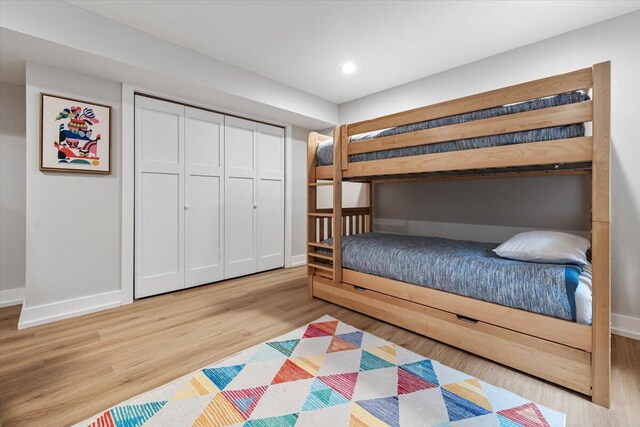 4067 Hillside Trl, New Buffalo, MI 49117 - bedroom with light wood finished floors, baseboards, a closet, and recessed lighting
