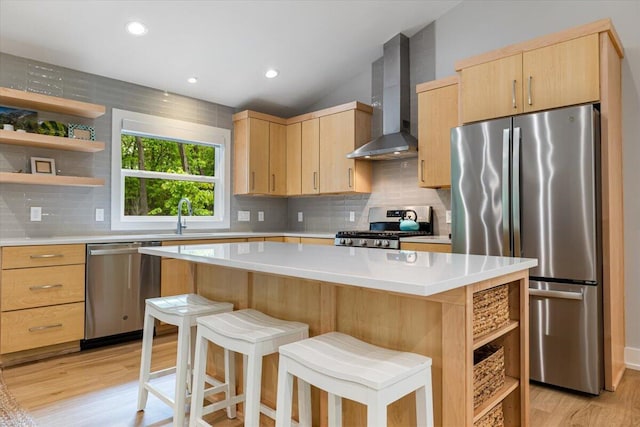 4067 Hillside Trl, New Buffalo, MI 49117 - kitchen featuring appliances with stainless steel finishes, wall chimney exhaust hood, open shelves, light brown cabinetry, and vaulted ceiling