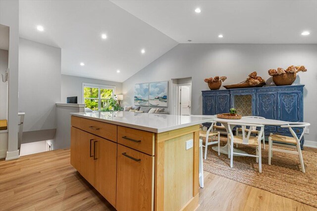 4067 Hillside Trl, New Buffalo, MI 49117 - kitchen featuring a center island, light wood-style floors, light countertops, lofted ceiling, and recessed lighting