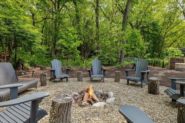 4067 Hillside Trl, New Buffalo, MI 49117 - view of patio featuring a fire pit and a view of trees