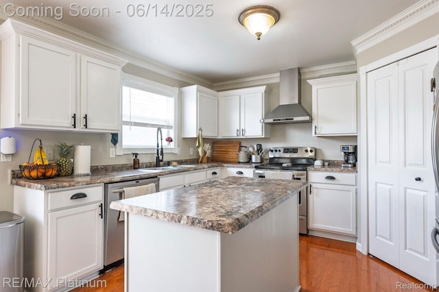 2858 Au Gres River Dr, Fowlerville, MI 48836 - kitchen featuring wall chimney exhaust hood, appliances with stainless steel finishes, a sink, white cabinets, and ornamental molding