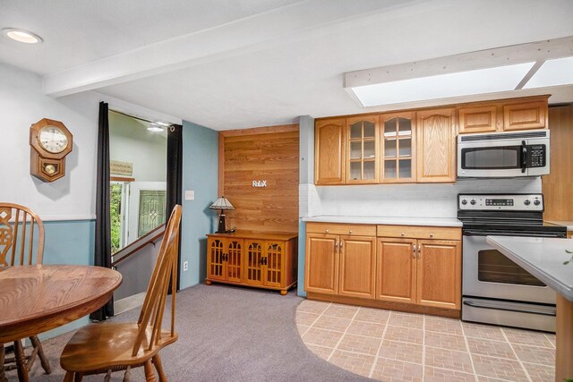 4468 Teal Ln, Newaygo, MI 49337 - kitchen featuring stainless steel appliances, light countertops, beam ceiling, glass insert cabinets, and tasteful backsplash
