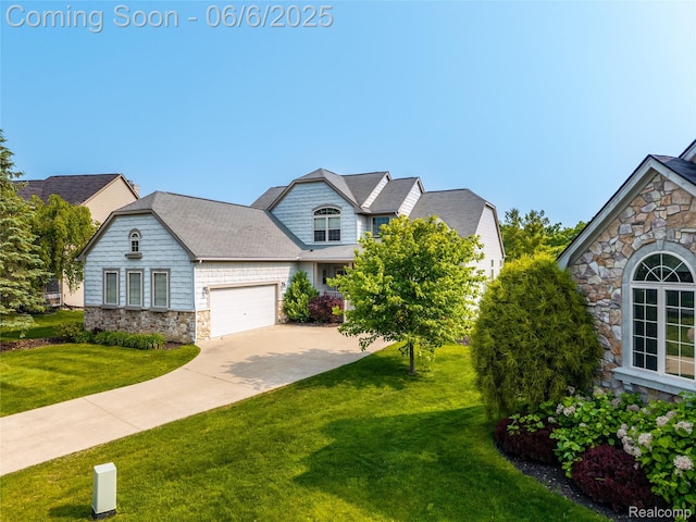 2327 Cherry Tree Ln, Grand Blanc, MI 48439 - view of front of home featuring stone siding, a front yard, driveway, and a garage