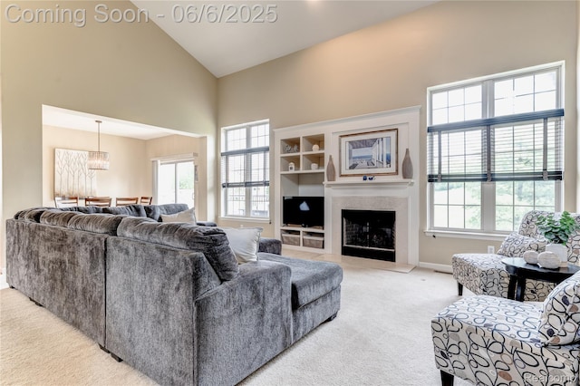 2327 Cherry Tree Ln, Grand Blanc, MI 48439 - living area featuring high vaulted ceiling, light colored carpet, a premium fireplace, and baseboards