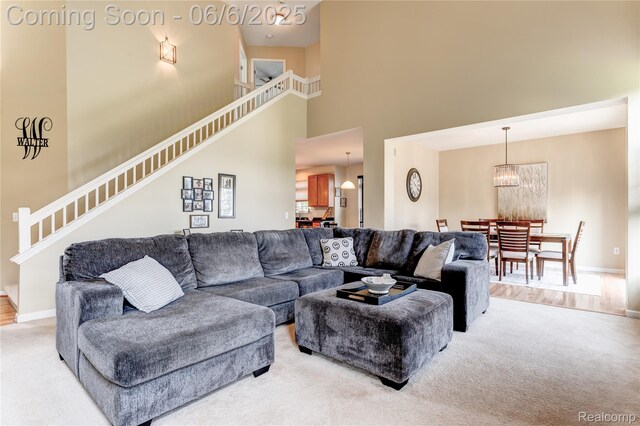 2327 Cherry Tree Ln, Grand Blanc, MI 48439 - living room with a towering ceiling, stairway, light colored carpet, and baseboards