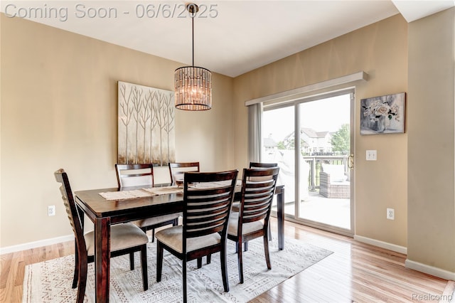 2327 Cherry Tree Ln, Grand Blanc, MI 48439 - dining room with light wood-style flooring, a chandelier, and baseboards