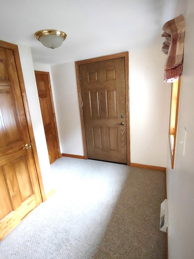11883 Scott Park Rd, Delton, MI 49046 - foyer entrance featuring baseboards and light carpet