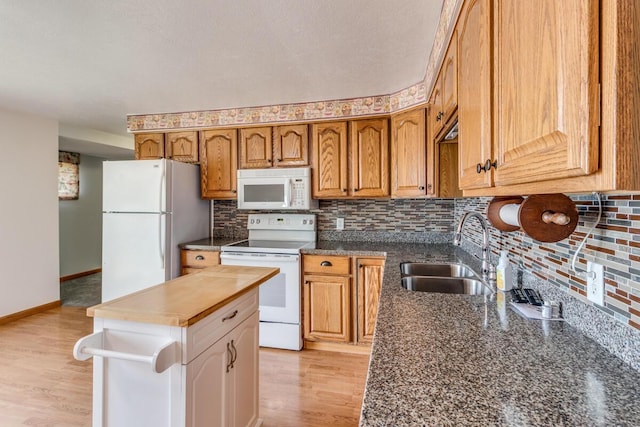 11883 Scott Park Rd, Delton, MI 49046 - kitchen with white appliances, a sink, tasteful backsplash, and baseboards