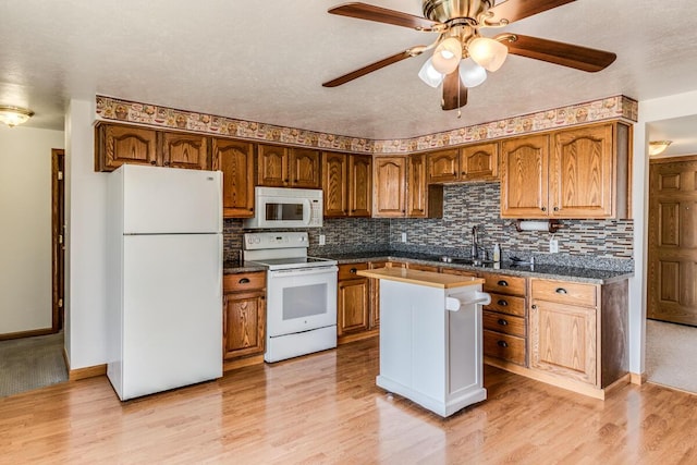 11883 Scott Park Rd, Delton, MI 49046 - kitchen with white appliances, decorative backsplash, and light wood-style flooring