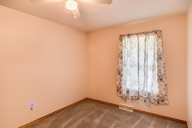 11883 Scott Park Rd, Delton, MI 49046 - spare room with a ceiling fan, baseboards, and dark colored carpet