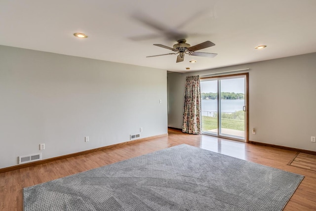 11883 Scott Park Rd, Delton, MI 49046 - unfurnished room featuring a ceiling fan, light wood-style flooring, baseboards, a water view, and recessed lighting